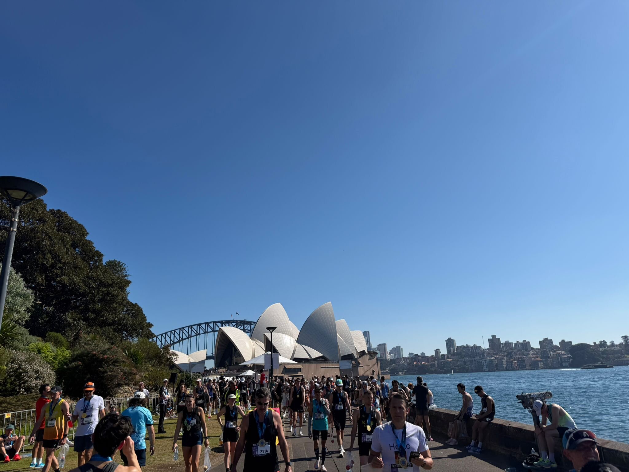 Finishers gathered on the steps of the Sydney Opera House after the 2026 TCS Sydney Marathon